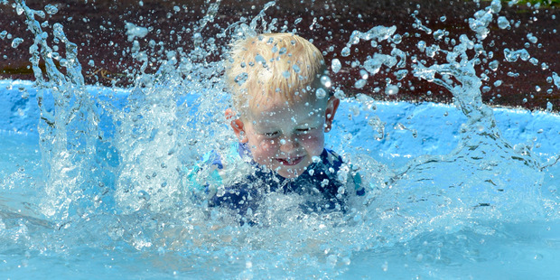 Dunedin 2-year-old Toby Gullen-Baker gets a feel for summer in a paddling pool at the city's Woodhaugh Gardens yesterday. Photo / Otago Daily Times