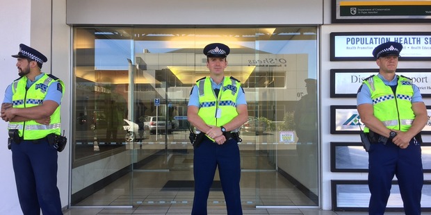Hamilton police stand guard outside the Hamilton regional office of Department of Corrections this morning. Photo / Belinda Feek
