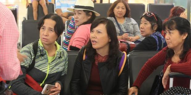 Concerned passengers at Sydney Airport after the frightening landing. Photo / Mark Evans, News Corp Australia