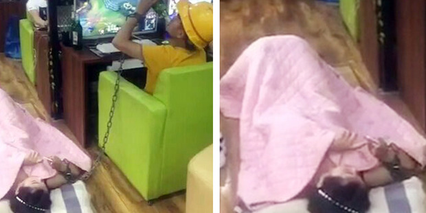 In photos of the bizarre incident the man can been swigging his beer while the girl lies beside him. Photo / AsiaWire