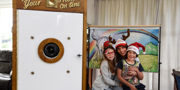 Anmea Hoskin with Layla and Lenny with all the proceeds of the photobooth will be donated to the Tauranga Community Food Bank appeal after the Omokoroa Pt School Christmas Fayre. Photo/George Novak