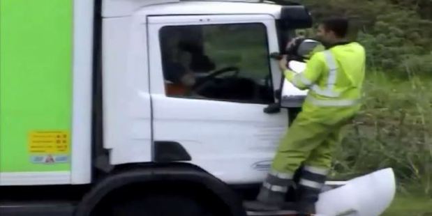 The van driver intimidated the two occupants of the white truck before taking to their window with a spade.