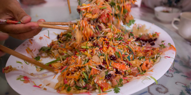 Prosperity toss consists of raw fish mixed with shredded vegetables and a variety of sauces and condiments. Photo / Dean Purcell