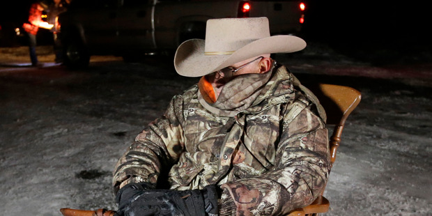 Arizona rancher LaVoy Finicum holds his gun tight as he guards the Malheur National Wildlife Refuge in Oregon. Photo / AP