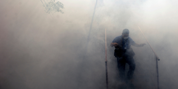 Health officials in San Salvador fumigate homes to prevent the spread of the Zika virus. Photo / Getty Images