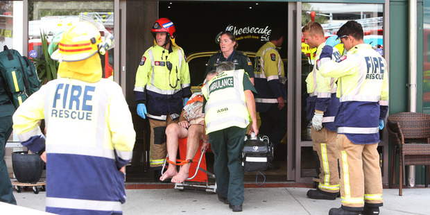 Emergency crews at the scene of the crash. The store's owner said the woman and child were waiting for a birthday cake when the crash occurred. Photo / Michael Cunningham