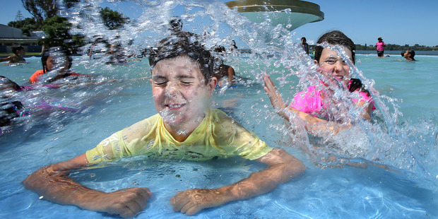Luka, 8, and India, 11 Mahy enjoy playing in the Memorial Park fountain. Photo/John Borren