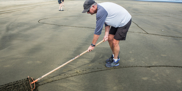 Chris proposed by writing words in the sand at Muriwai beach. Photo / Supplied by Chris Hoffmann.