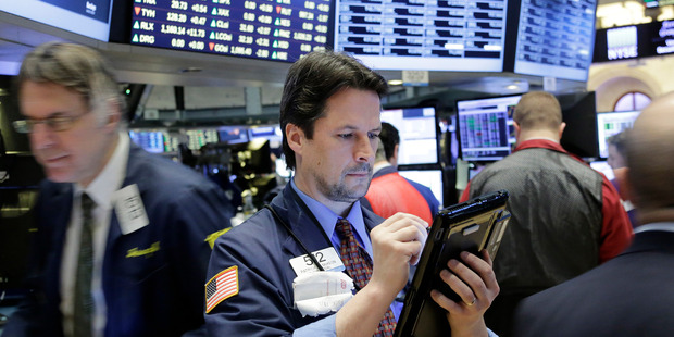 Traders work at the New York Stock Exchange. Photo / AP