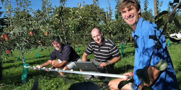 AWARD: Dr Stuart Tustin, left, received the Joe Bell Trophy for service to the industry, including his project to increase orchard production with Dr Ben van Hooildonk and Ken Breen. Photo/File