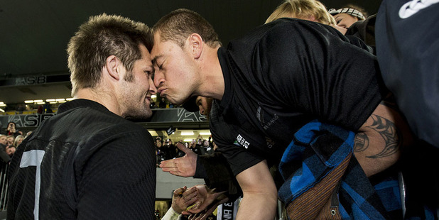 Richie McCaw shares a hongi with a fan after walking off Eden Park. Photo / Dean Purcell