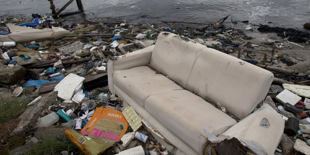 A file image from 2015 shows a discarded sofa on the shore of Guanabara Bay in Rio de Janeiro. Photo / AP