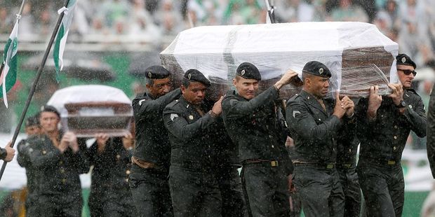 Coffins containing the remains of a victim of the plane crash in Colombia arrive at Arena Conda stadium. Photo / Getty Images