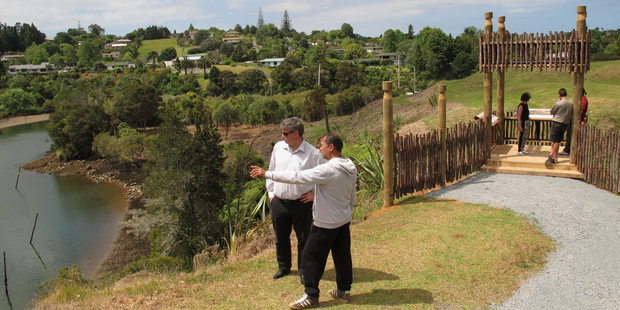 Ngati Rehia's Kipa Munro points out the sights from the newly revealed Kororipo Pa to Alan McKenzie of the Ministry for Culture and Heritage. Photo / Peter de Graaf