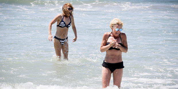 Swimmers Sandy Hamilton (foreground) and Kathryn Winiata go for a quick dip. Photo / Andrew Warner