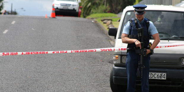Police have cordoned off an area of the road and armed police are standing guard. Photo / Daniel Hines