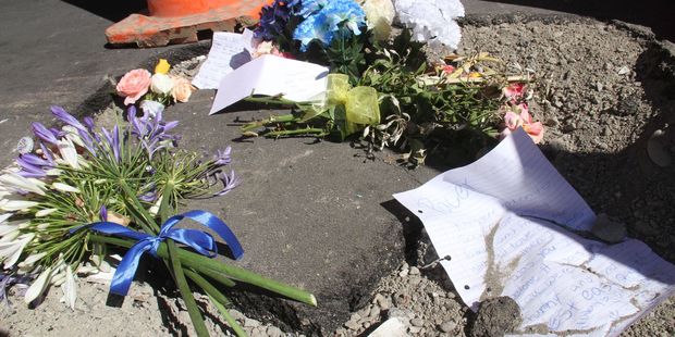 Flowers left at the crash site on Masterton's Queen St. Photo / Andrew Bonallack