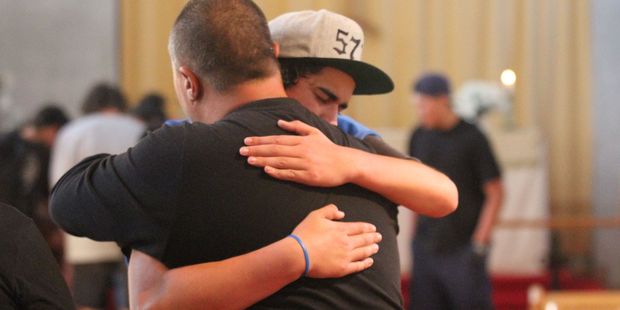 A teenager hugs Alan Maxwell, coordinator of Wairarapa Anglican Youth, during a vigil for Hoani Korewha and Pacer Willacy-Scott. Photo / Andrew Bonallack