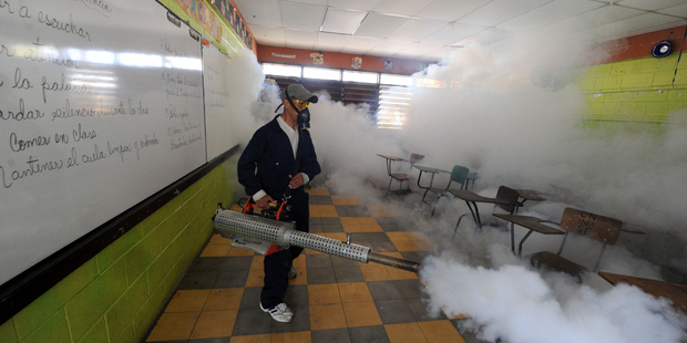 Health ministry personnel fumigate against the Aedes aegypti mosquito in Honduras. Photo / Getty