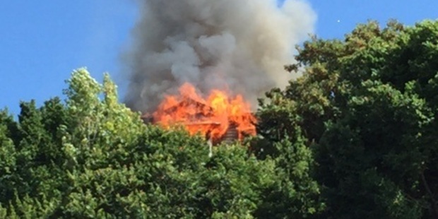 ON FIRE: A house on Napier Hill burns this morning. PHOTO/Annette Hilton - Newstalk ZB.