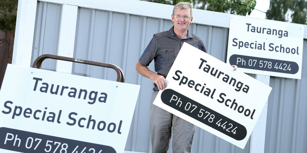 Kaka St Special School has been renamed as Tauranga Special School. Principal Barrie Wickens shows off the school's temporary signs. Photo / John Borren