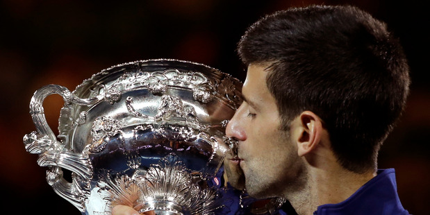 Novak Djokovic of Serbia kisses his trophy after defeating Andy Murray of Britain in the men's singles final at the Australian Open tennis championships. Photo / AP.