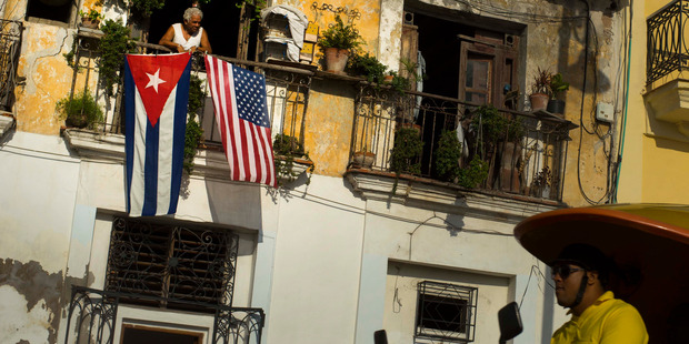 A U.S. and a Cuban national flag fly together symbolically in Old Havana. Photo / AP