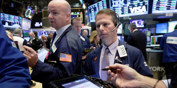 Trader Patrick Casey, left, and Robert Charmak work on the floor of the New York Stock Exchange. File photo / AP