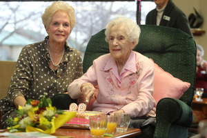 Rona McCarthy cuts the cake on her 99th birthday on August 21 with her only daughter Karin Campbell.