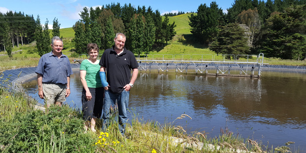 Don Compton (left) with Joanna and David Field of Woodlands Farm at Woodville, with the new effluent pond and stirrer on their property.