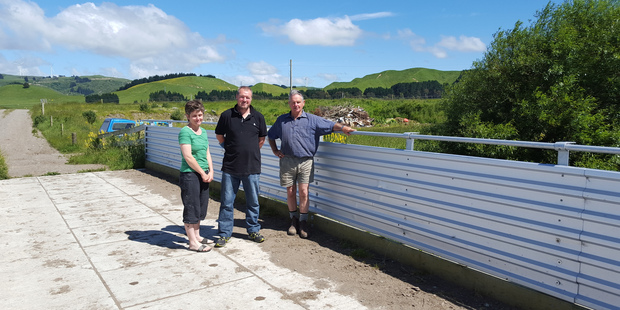 Joanna and David Field with Joanna's father Don Compton on the new bridge across the Mangapapa Stream at Woodville, built by the farming partnership at a cost of $90,000.