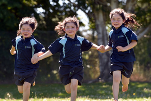 Olivia (left), Charlotte and Haylee Kelly, 6, are glad to be back at Milton Primary school for their second year. Photo / Peter McIntosh.