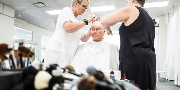 Ali Brill, left, and Donna Rae transform Chris Crowe into the Phantom with makeup and prosthetics. Photo / Michael Craig