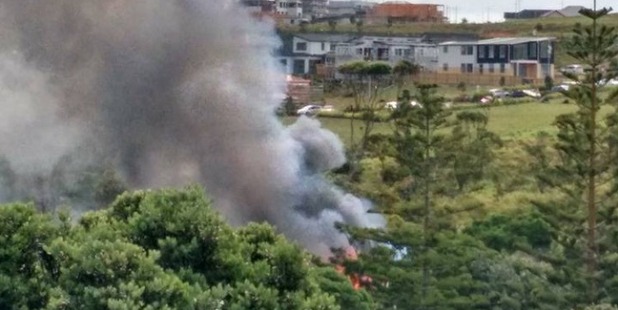 Smoke billows from the burning house. Photo / Chris Wells