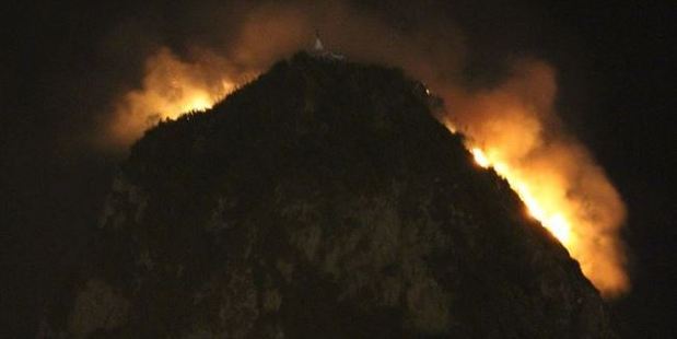 Fire crews were called to Paritutu Rock at about 9.30pm Friday. Photo / Facebook, The Bus