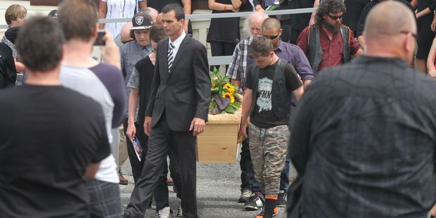 Mourners carry the casket of Pacer Willacy-Scott from the Anzac Hall in Featherston. Photo / Andrew Bonallack