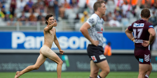 To loud cheers from the crowd, the man runs past players and a number of security guards. Photo / Brett Phibbs