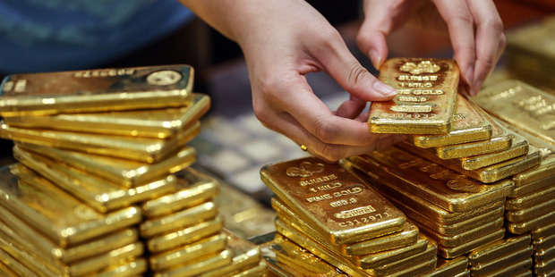An employee arranges one kilogram gold bars for a photograph at the YLG Bullion International Co. headquarters in Bangkok, Thailand. Photo / Bloomberg