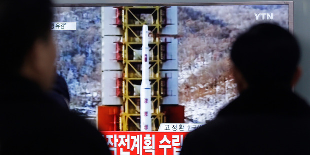 People watch a TV news reporting a rocket launch in North Korea, at Seoul Railway Station in Seoul. Photo / AP