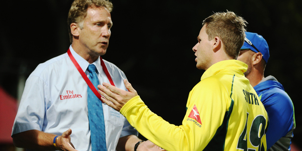 Steve Smith of Australia speaks with match referee Chris Broad after a controversial decision which dismissed Mitchell Marsh. Photo/Getty