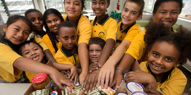 Pupils from Christ the King School, Mt Roskill, with some of the KidsCan food parcels. Photo / Brett Phibbs
