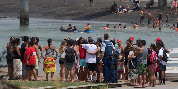 Whanau and friends of the Raglan 16-year-old gather opposite the footbridge from which he jumped. Photo / Alan Gibson