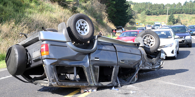A car on its roof on SH2 near Apata. Photo/Stuart Whitaker