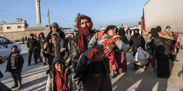 Syrians gather at the Bab al-Salam border gate with Turkey. Photo / AP