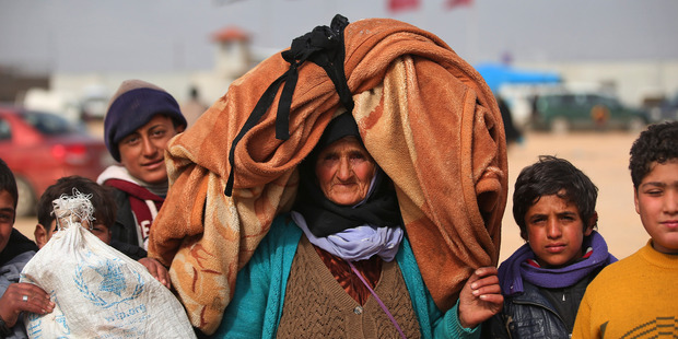 Syrians, some carrying belongings, flock towards the border. Photo / AP