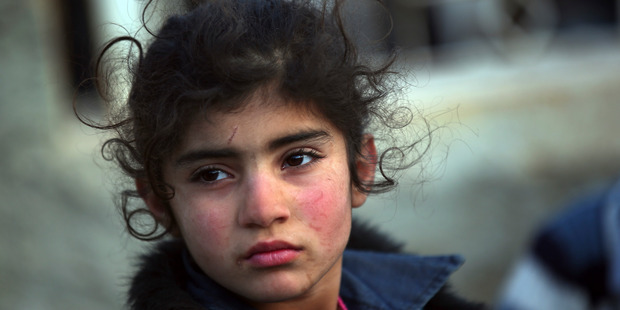 A Syrian child arrives at the Bab al-Salam border crossing as thousands flee the Syrian Government offensive. Photo / AP