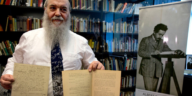 Hebrew University's Roni Gross holds the original historical documents related to Albert Einstein's prediction of the existence of gravitational waves at the Hebrew university in Jerusalem. Photo / AP