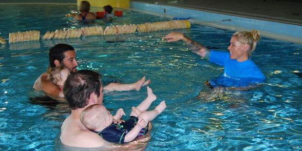 Charli with dad Matt Johnson, left, and Jacob with dad Garry Dillon practise moving in water with Swim Magic co-ordinator Hollee Wilton. PHOTO/ALISA YONG