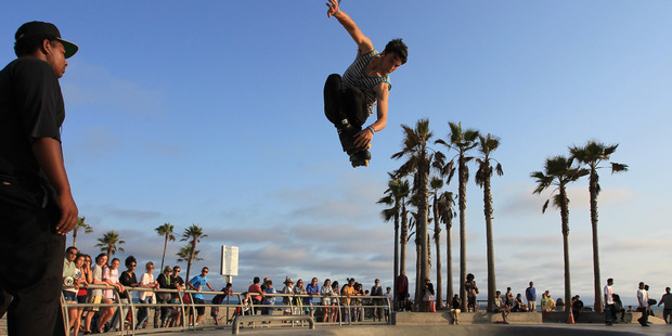 Isaac Mercado makes a jump on rollerblades at Venice Beach, California. Air fares between New Zealand and California have just dipped to below $400 one way. Photo / Getty