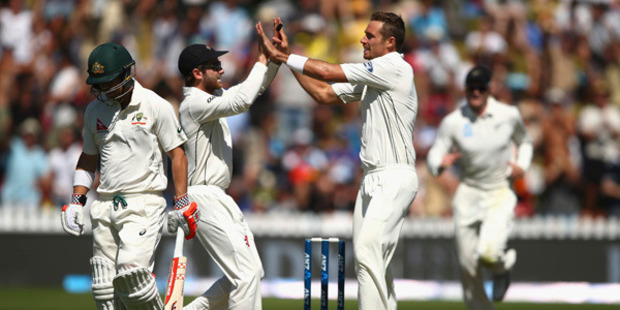Tim Southee of New Zealand celebrates after taking the wicket of David Warner of Australia. Photo / Getty Images